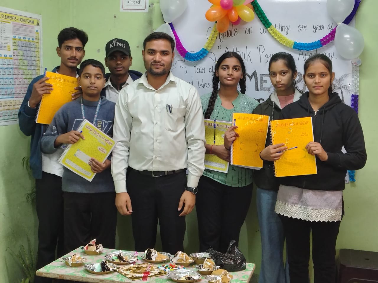 Students celebrate an anniversary with their teacher at the academy