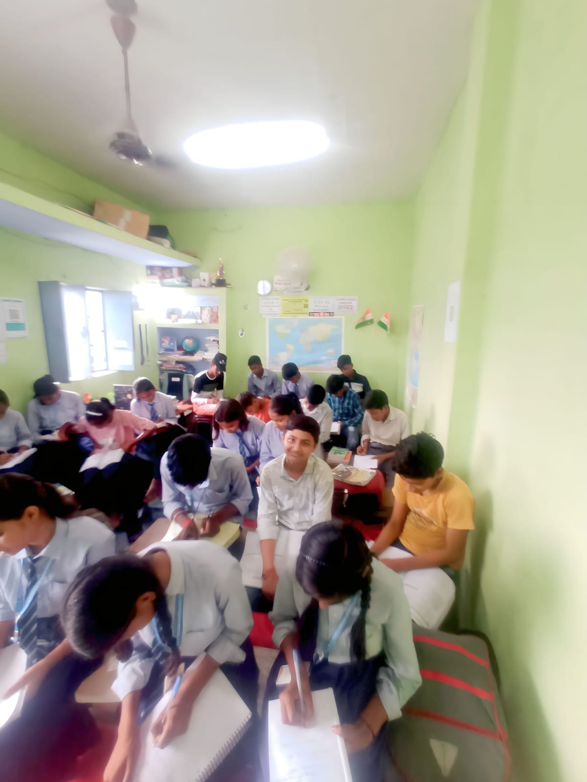Students write practice papers during a classroom session