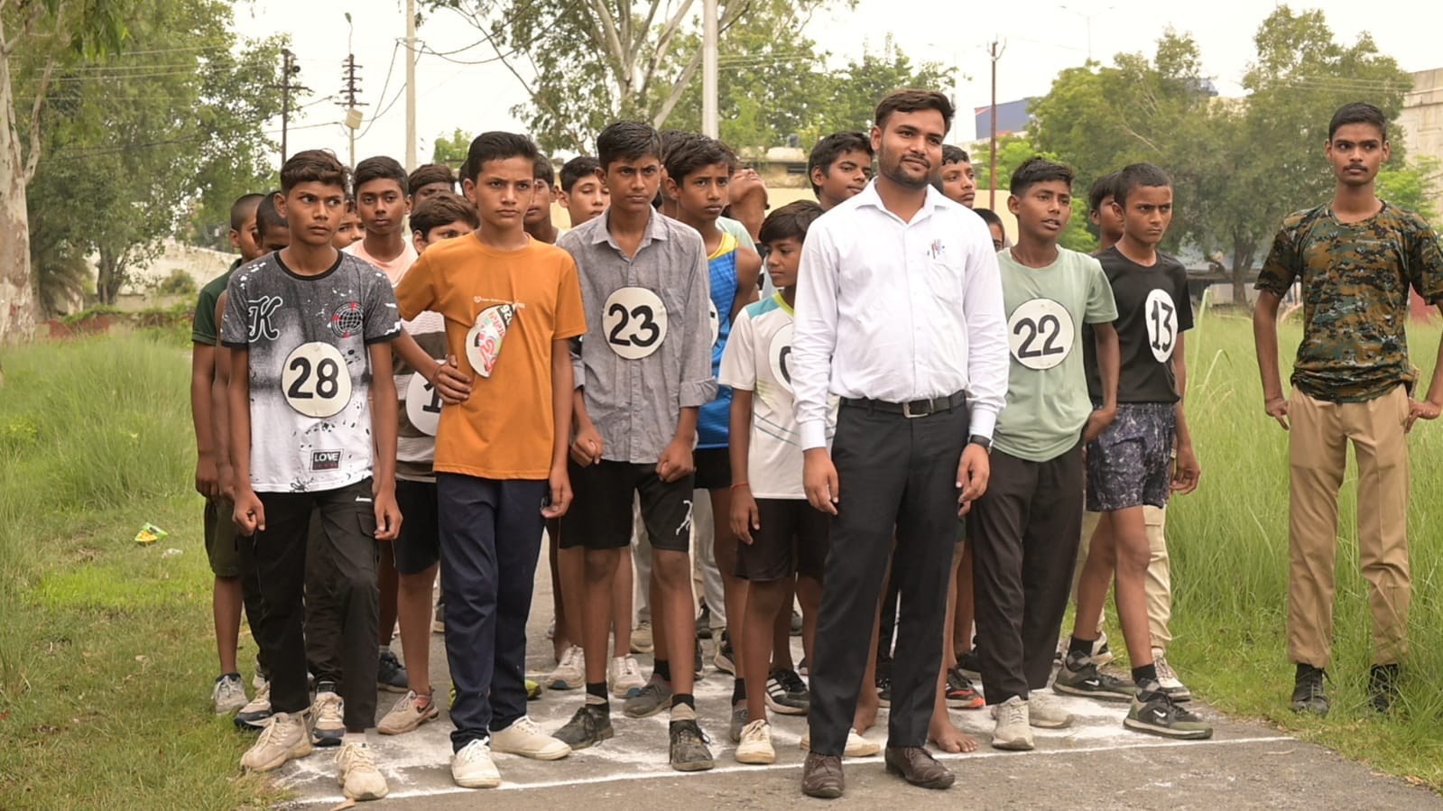 Students line up for an outdoor academy sports race