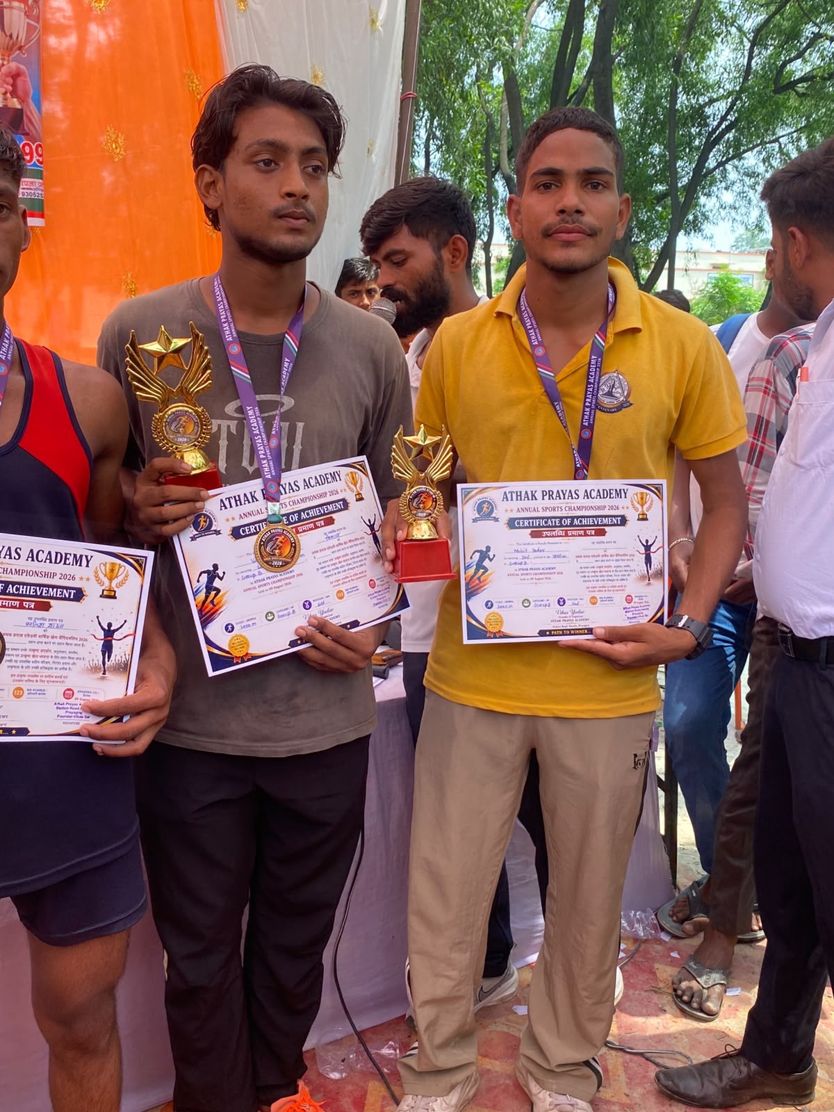 A student receives a certificate at the academy sports event