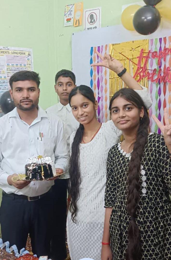 Students celebrate with their teacher at the academy