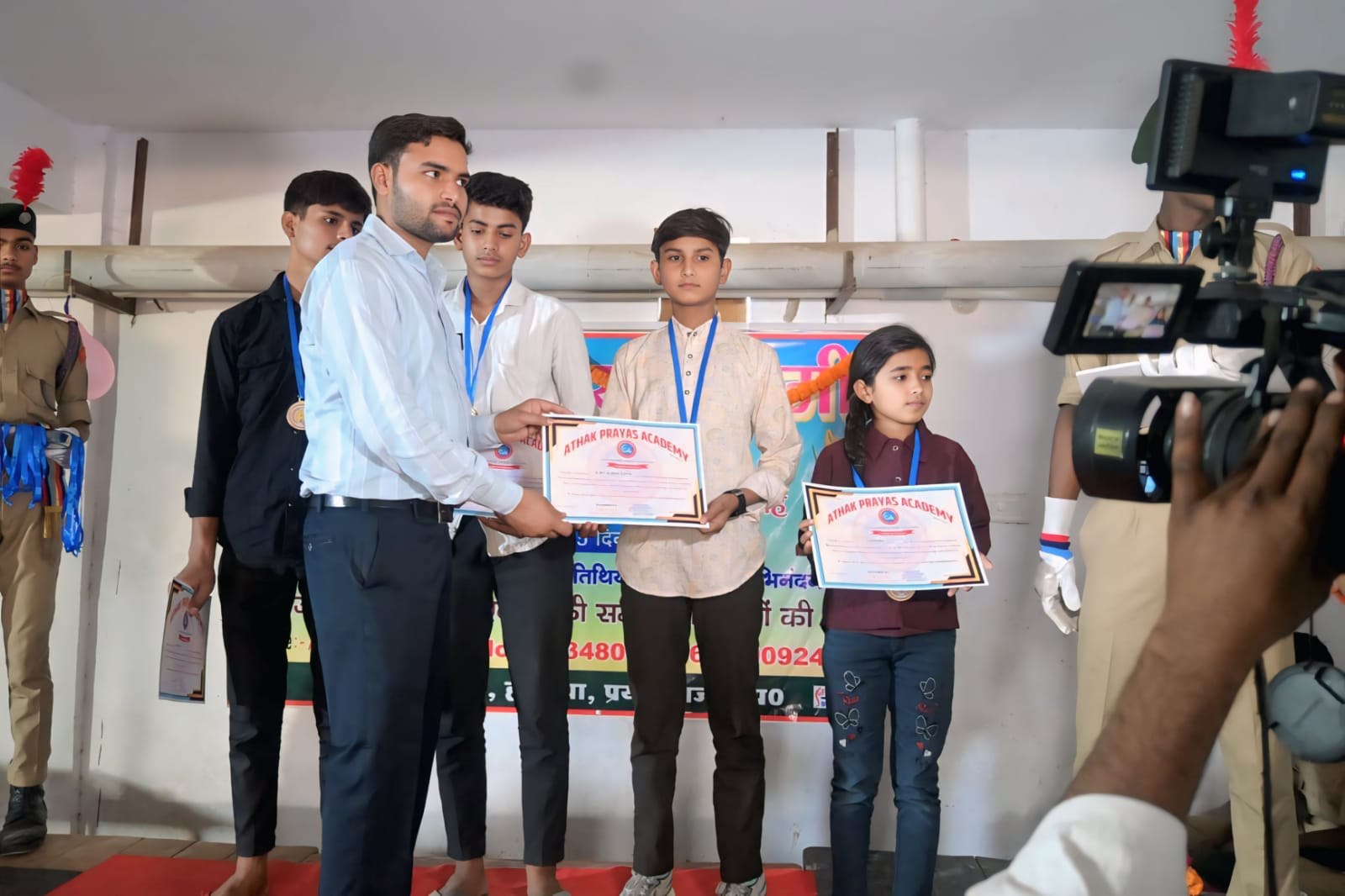 Students receive certificates during an academy award ceremony