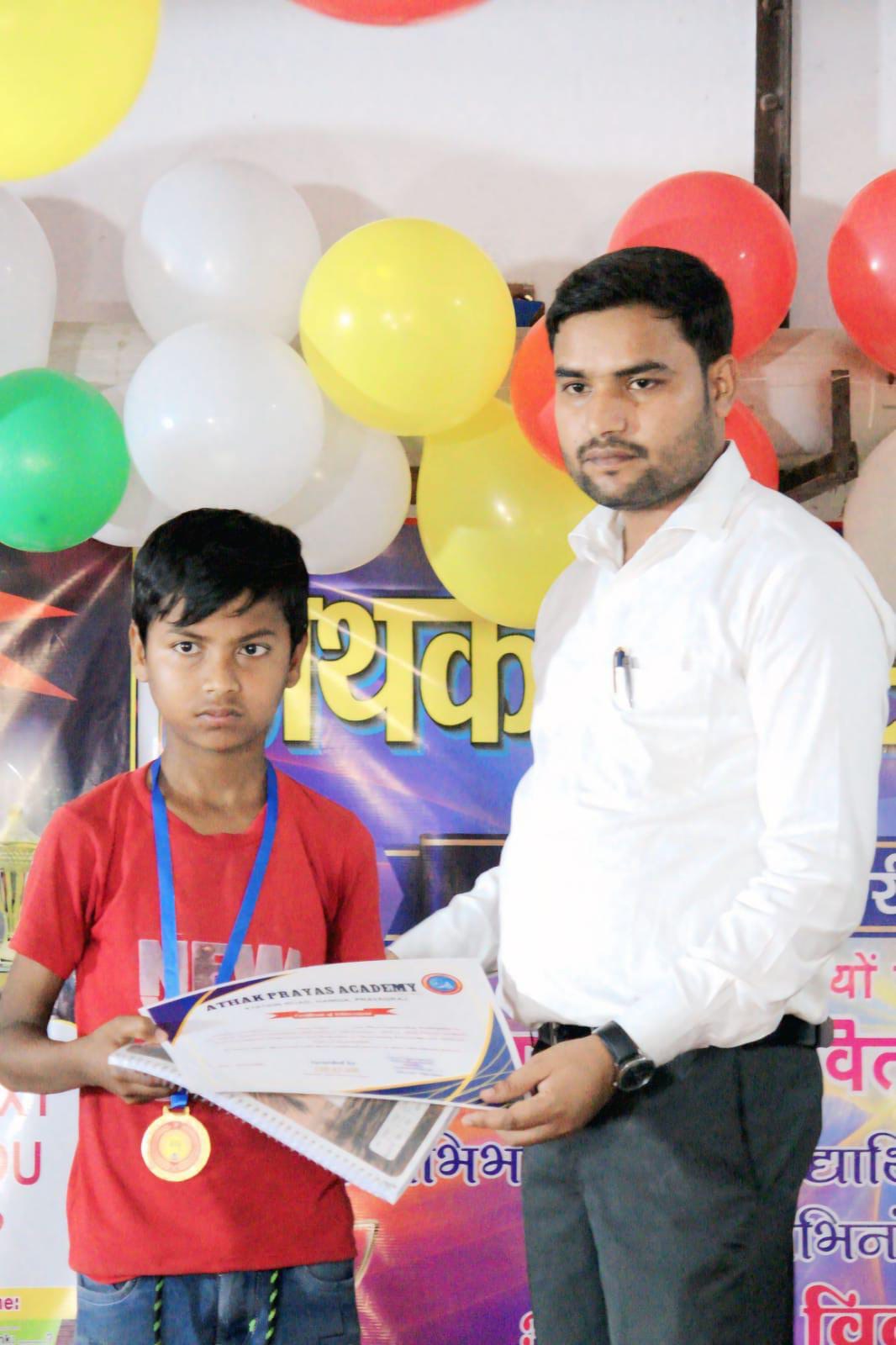 A student receives a certificate from the academy teacher