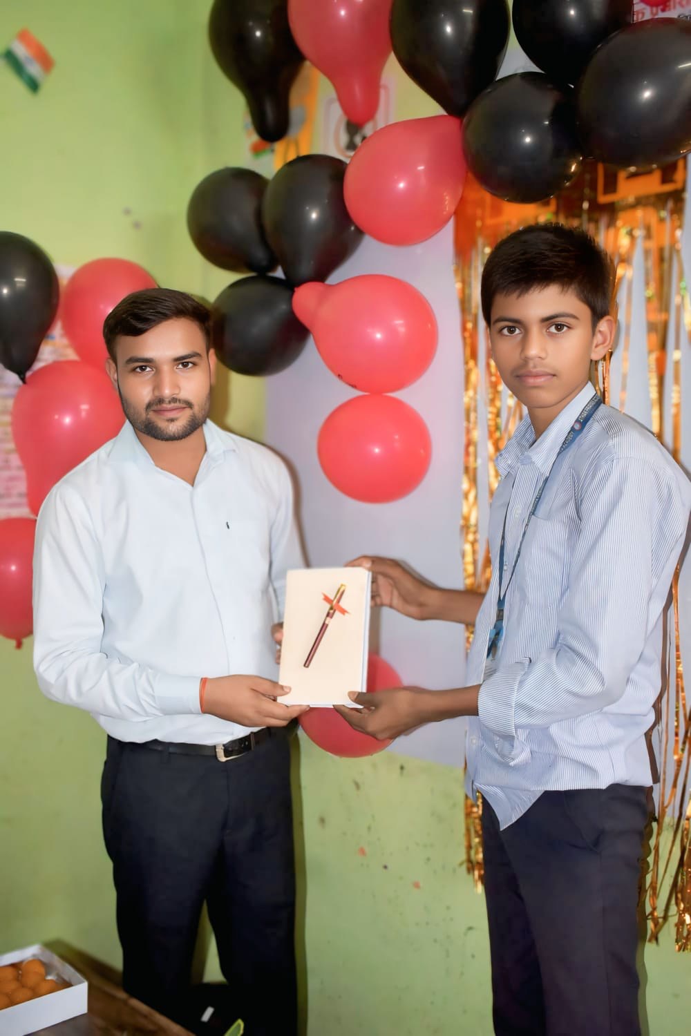 A student receives a prize from the academy teacher